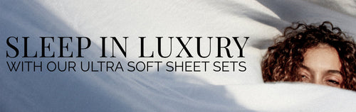 Sleep in luxury with ultra-soft patterned sheets, featuring a woman comfortably wrapped in stylish and high-quality bedding.