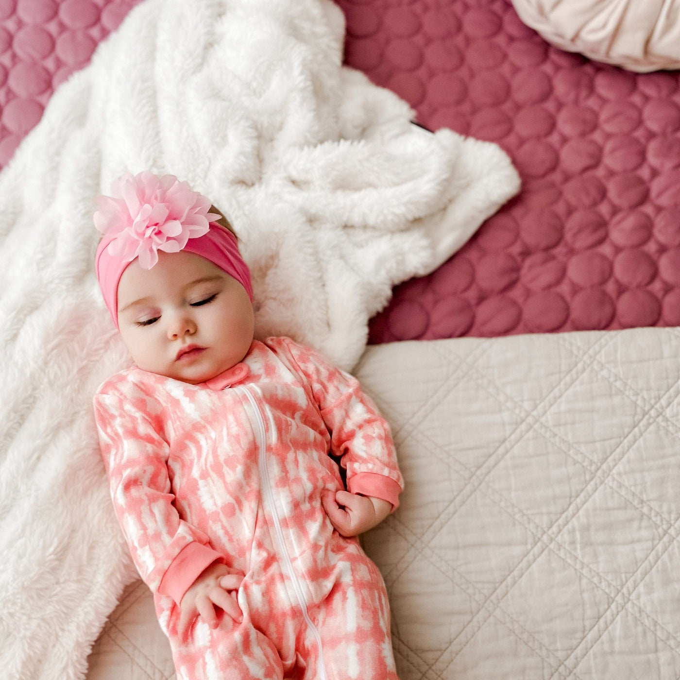 Baby lying down on Southshore Essentials Quilt Set in Rose#color_rose