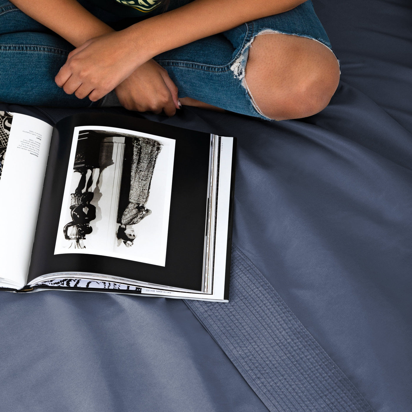 Lady Reading A Magazine on Vilano Extra Deep Pocket Pleated Sheet Set in Dark Blue#color_vilano-dark-blue