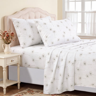 Taupe bedding set with a delicate dandelion print, styled on a bed with a tufted headboard, matching pillows, and a coordinating nightstand in a bright bedroom.
#color_dreamseed-taupe
