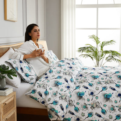 Lady having coffee on bed with Grand Symphony Duvet Cover in Blue#color_grand-symphony-blue