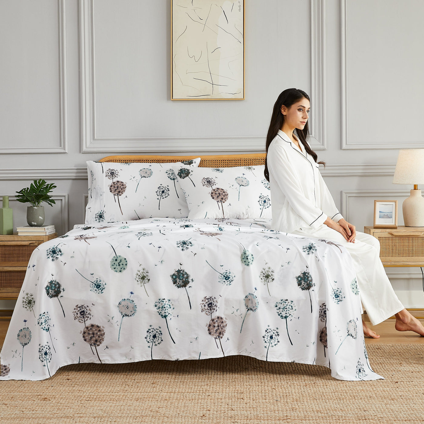 Lady sitting on bed with Dandelion Dreams Sheet Set in White#color_dandelion-white