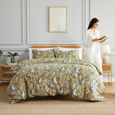 Lady reading a book next to Paradise Duvet Cover in Off White#color_paradise-off-white