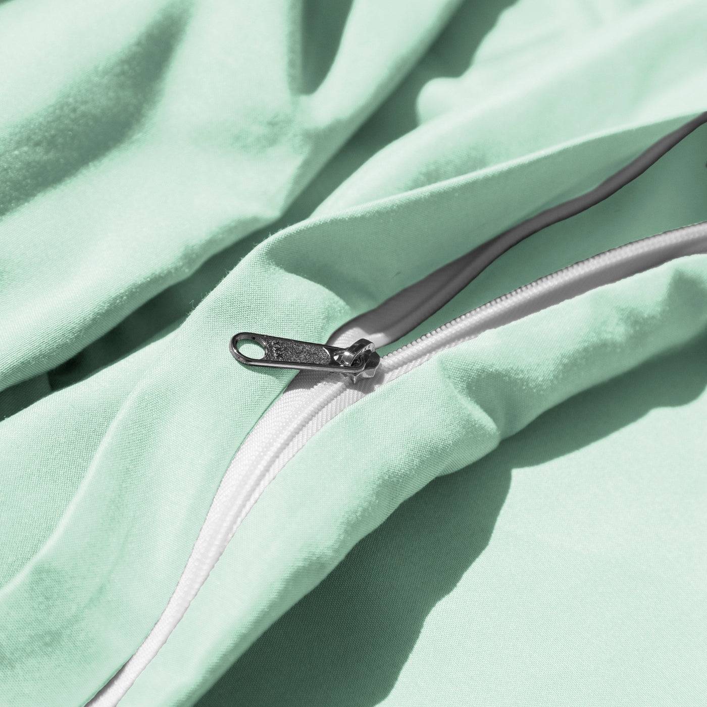 Close Up Image of Zipper Enclosure of Everyday Essentials Duvet Cover Set in Light Green#color_light-green