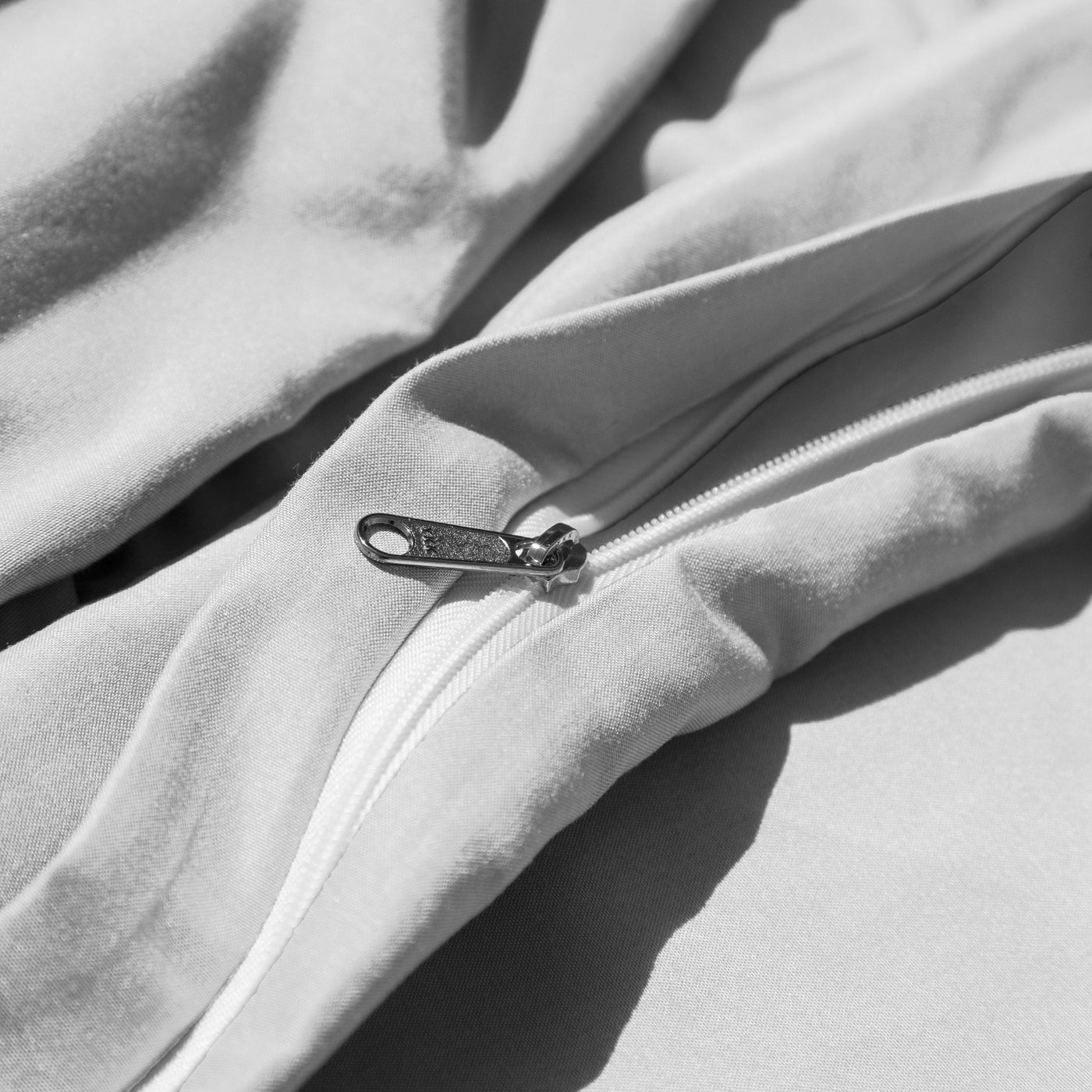 Close Up Image of Zipper Enclosure of Everyday Essentials Duvet Cover Set in Light Grey#color_light-grey