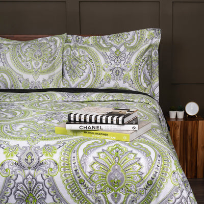 Half Front View of Pure Melody Comforter Set in Green with books and magazines on top#color_pure-melody-green