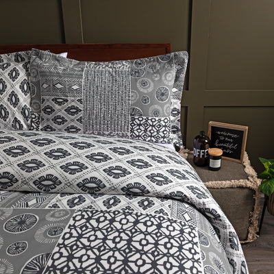 Half Front View of Global Patchwork Duvet Cover Set in Grey#color_patchwork-grey
