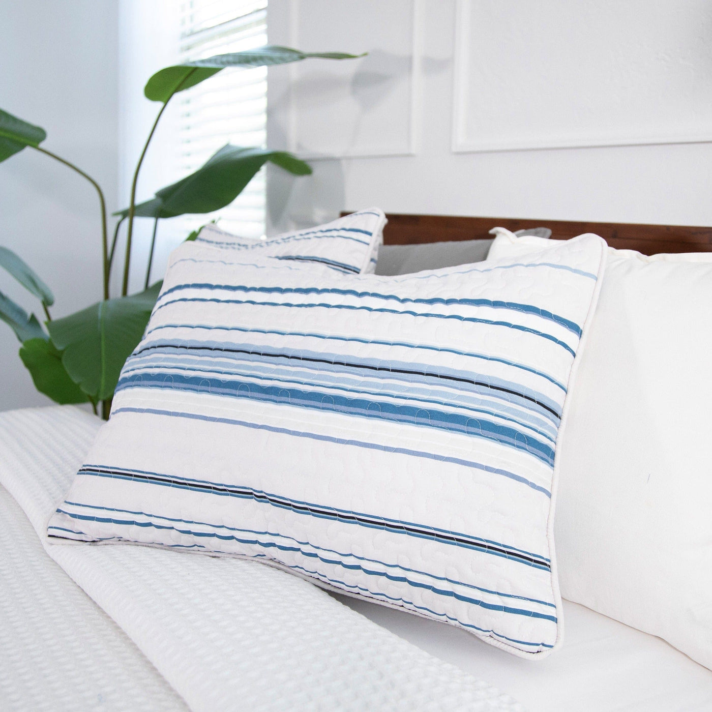 Angled View of Coastal Stripes Quilted Sham Covers in Blue#color_coastal-stripe-blue