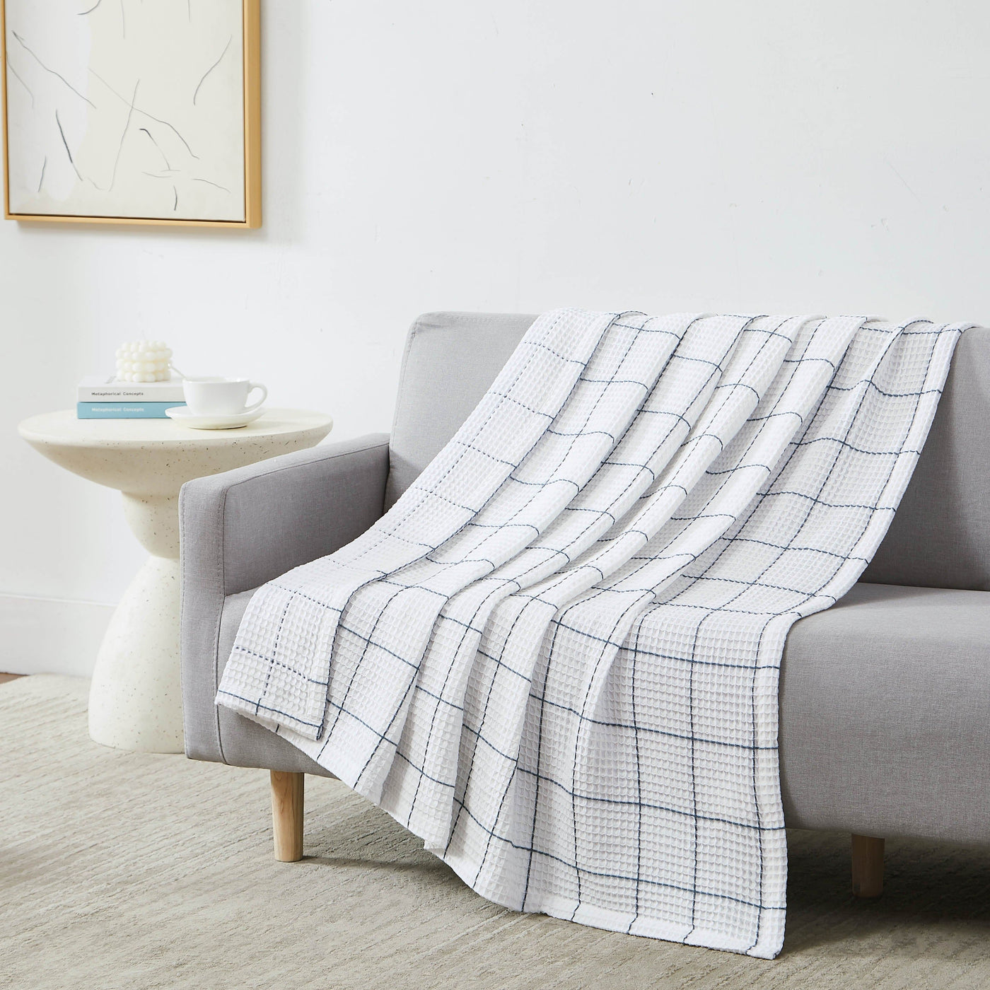 Check Cotton Blanket and Throw in white on sofa#color_white-with-blue-check