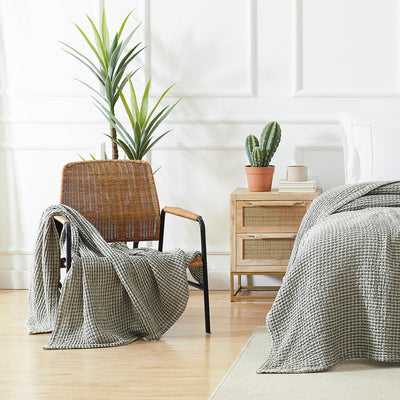 Tama Cotton Blanket and Throw in green on chair#color_tama-green