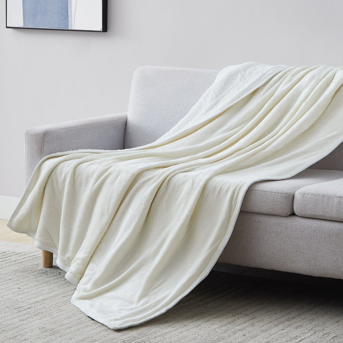 Sherpa-Fleece Oversized Reversible Blankets and Throws in Cream on Sofa#color_microfleece-cream