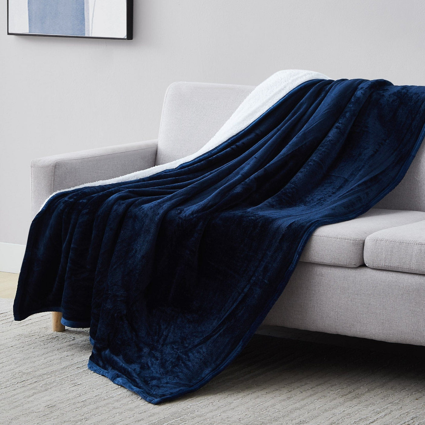 Sherpa-Fleece Oversized Reversible Blankets and Throws in Navy Blue on Sofa#color_microfleece-navy-blue