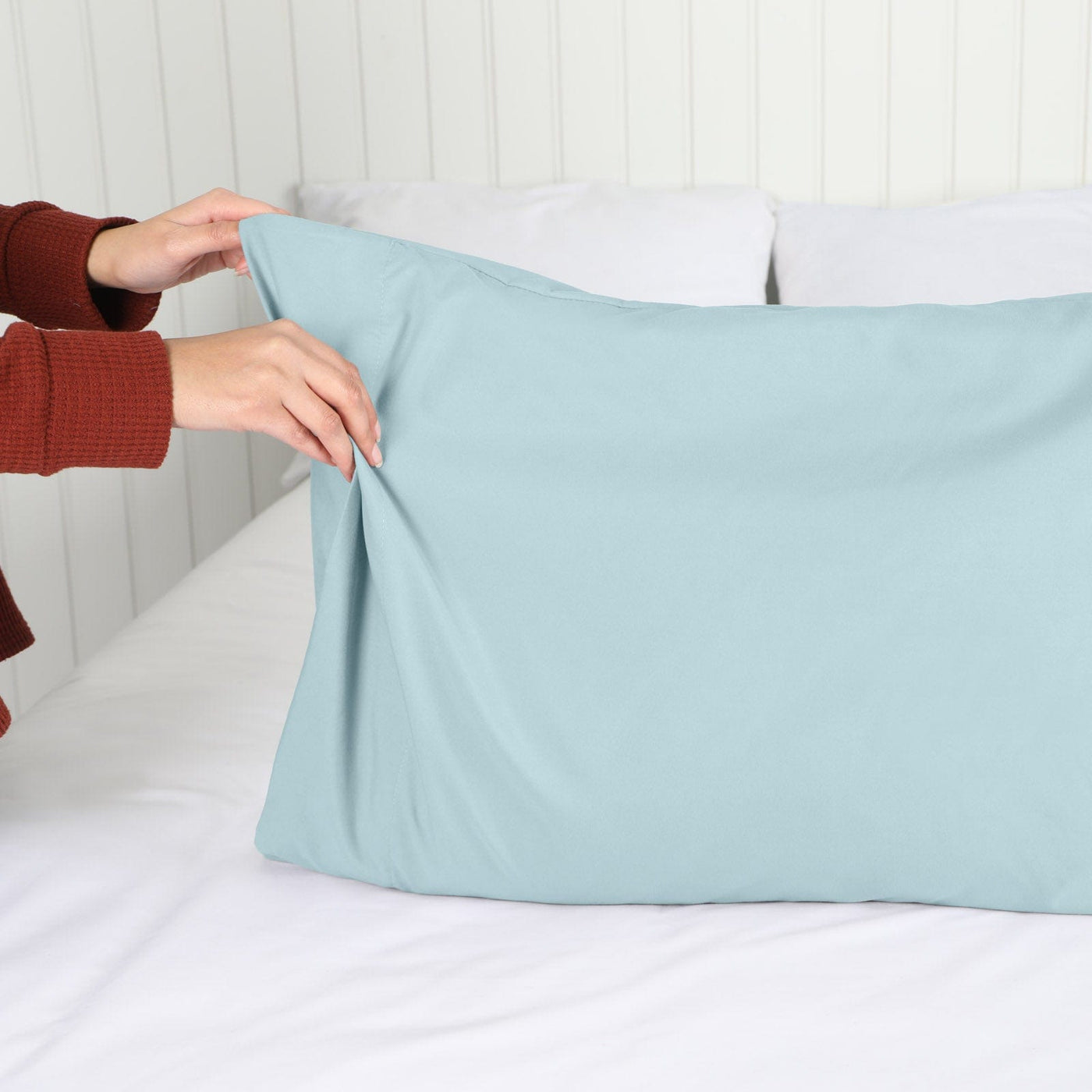 Lady setting up a Vilano Springs 2-Piece Pillow Cases in Sky Blue#color_vilano-sky-blue