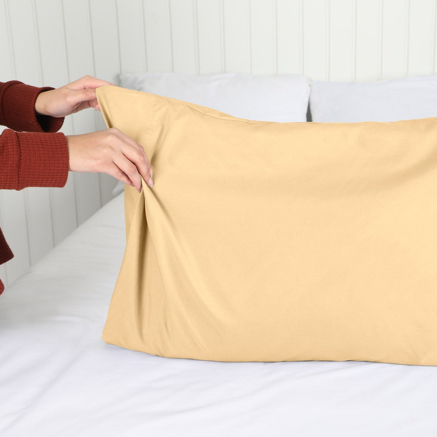 Lady setting up a Vilano Springs 2-Piece Pillow Cases in Gold#color_vilano-gold