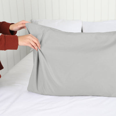 Lady setting up a Vilano Springs 2-Piece Pillow Cases in Steel Grey#color_vilano-steel-gray