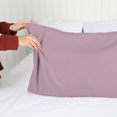 Lady setting up a Vilano Springs 2-Piece Pillow Cases in Lavender#color_vilano-lavender