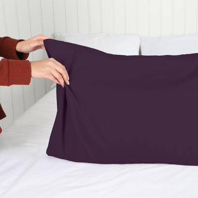 Lady setting up a Vilano Springs 2-Piece Pillow Cases in Purple#color_vilano-purple