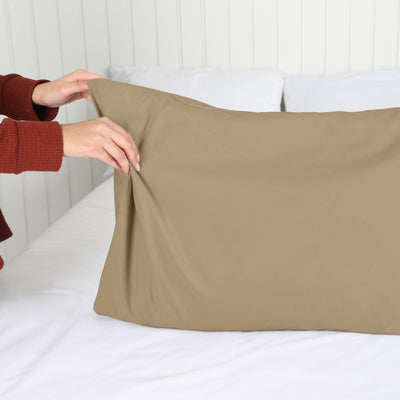 Lady setting up a Vilano Springs 2-Piece Pillow Cases in Taupe#color_vilano-taupe