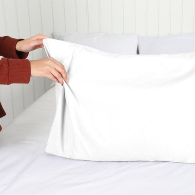 Lady setting up a Vilano Springs 2-Piece Pillow Cases in White#color_vilano-bright-white