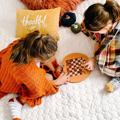 Two kids playing checkers on Southshore Essentials Quilt Set in White#color_bright-white