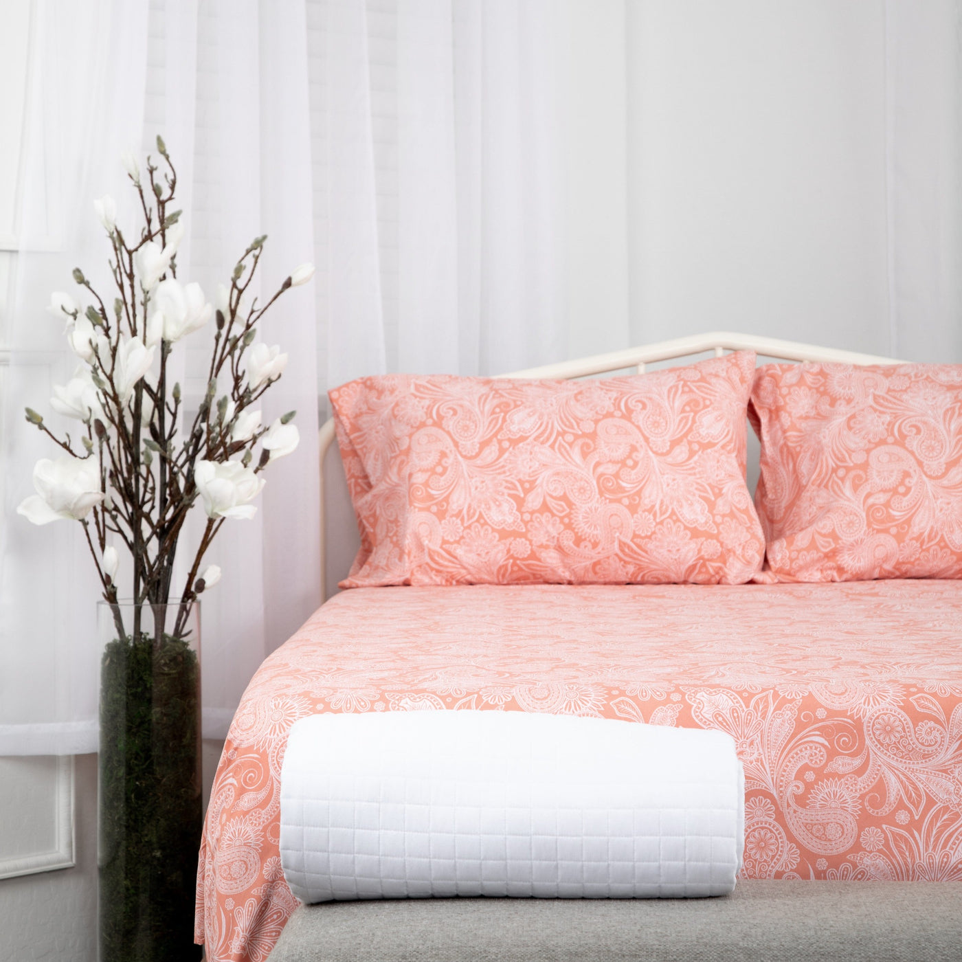 Half Front View of Perfect Paisley Sheet Set in Coral#color_perfect-paisley-coral-haze-with-white