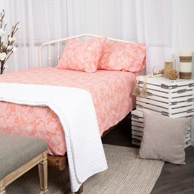 Angled View of Perfect Paisley Sheet Set in Coral#color_perfect-paisley-coral-haze-with-white