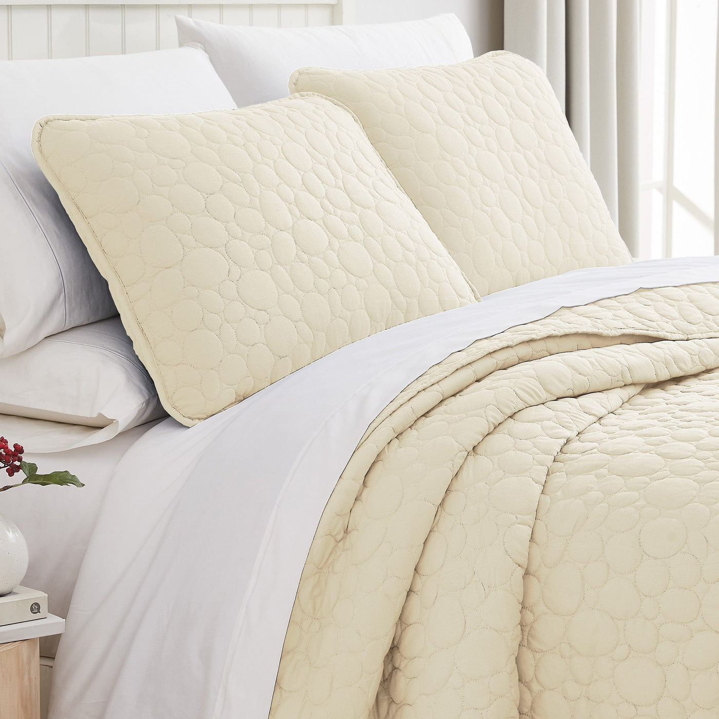 Angled View of Pebbles Oversized Quilt Set in Cream#color_pebbles-cream