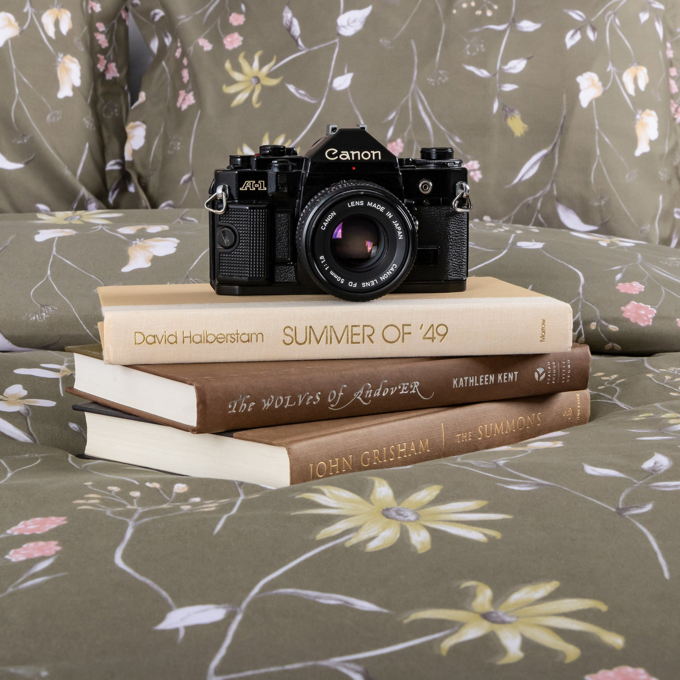 Camera and set of books on Secret Meadow Comforter Set in Olive Brown#color_secret-meadow-olive-brown