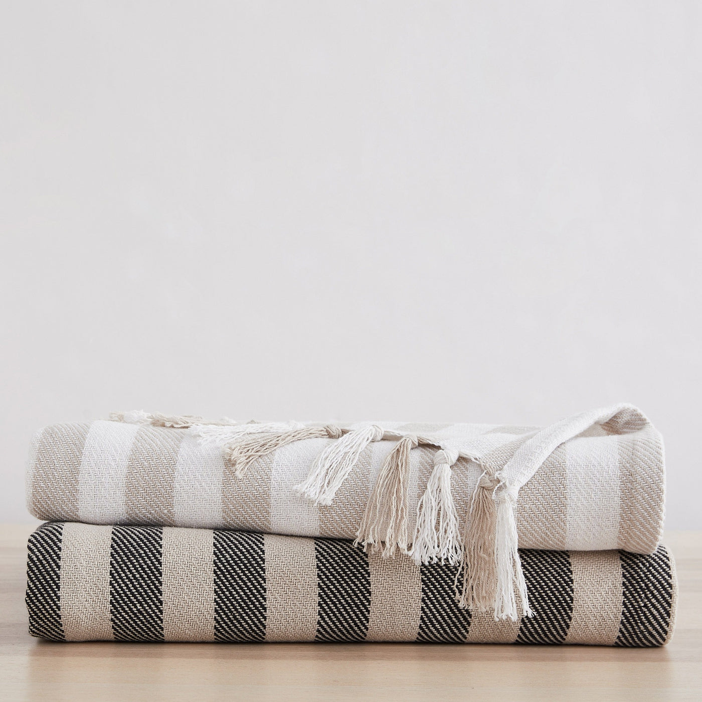 Striped Cotton Blankets and Throws in Black and Taupe Stack Together#color_striped-black