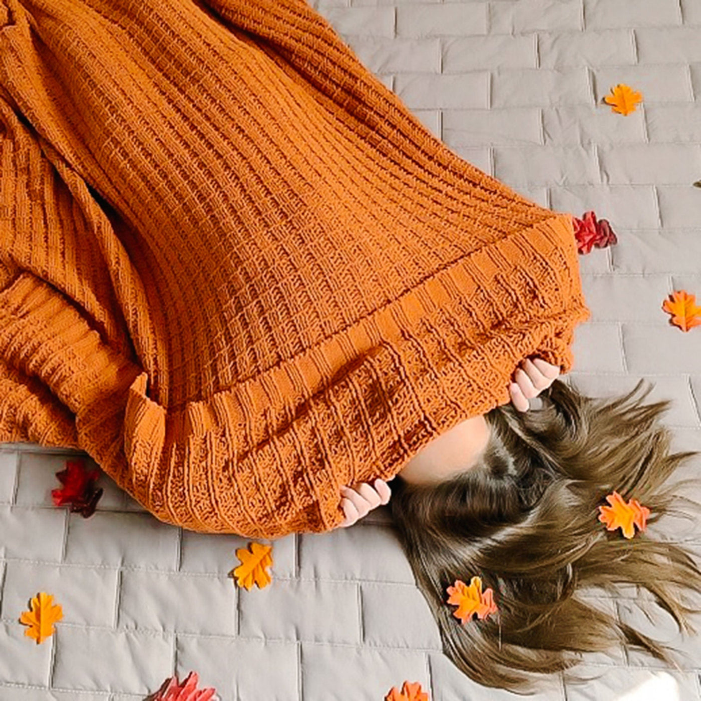 Lady hiding in blanket on Brickyard Collection Quilt Set in Bone#color_vilano-bone