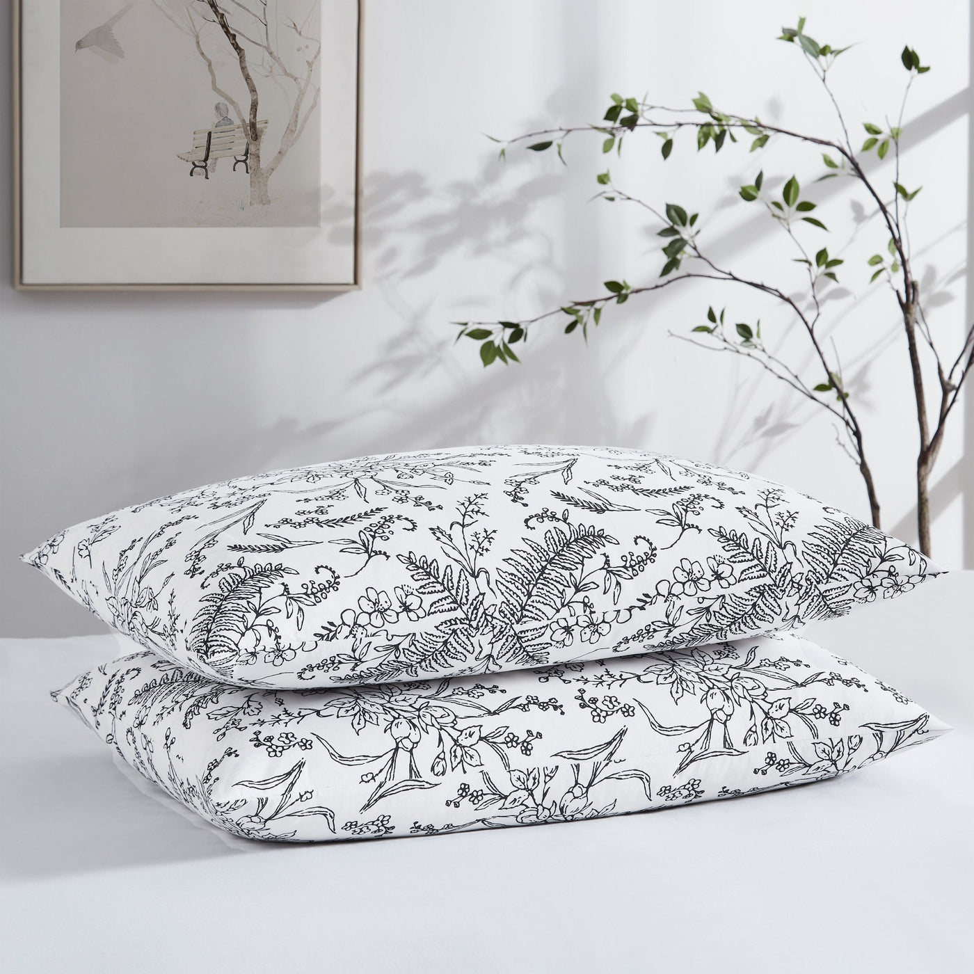Two Winter Brush Pillowcases in White and Black Flowers Stack Together#color_winter-brush-white-with-black-flowers