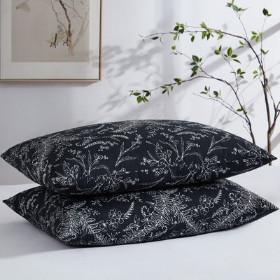 Two Winter Brush Pillowcases in Black and White Flowers Stack Together#color_winter-brush-black-with-white-flowers